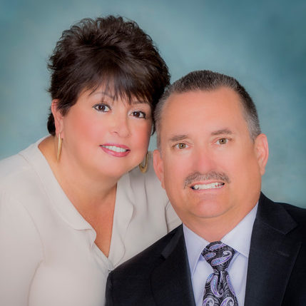 A man and woman posing for a picture.